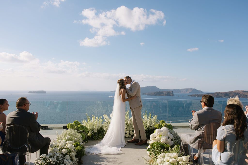 bride and groom kissing at wedding in Santorini greece